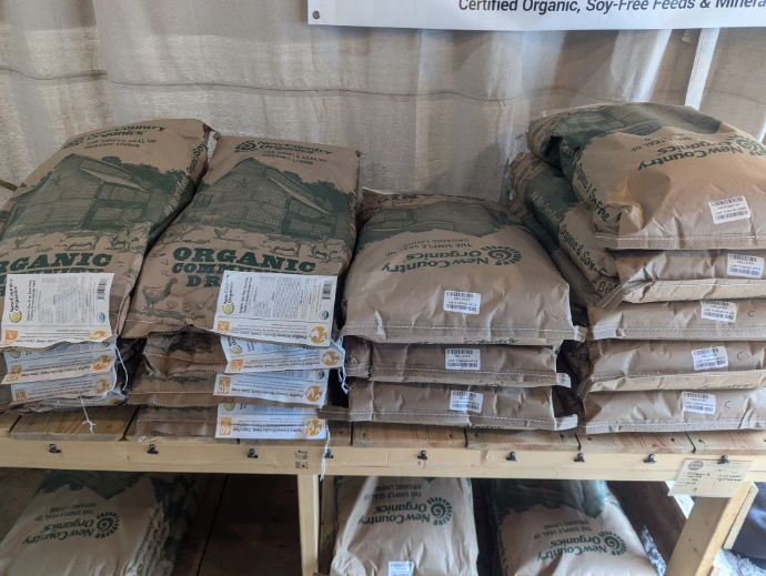 feed bags stacked on a wood table